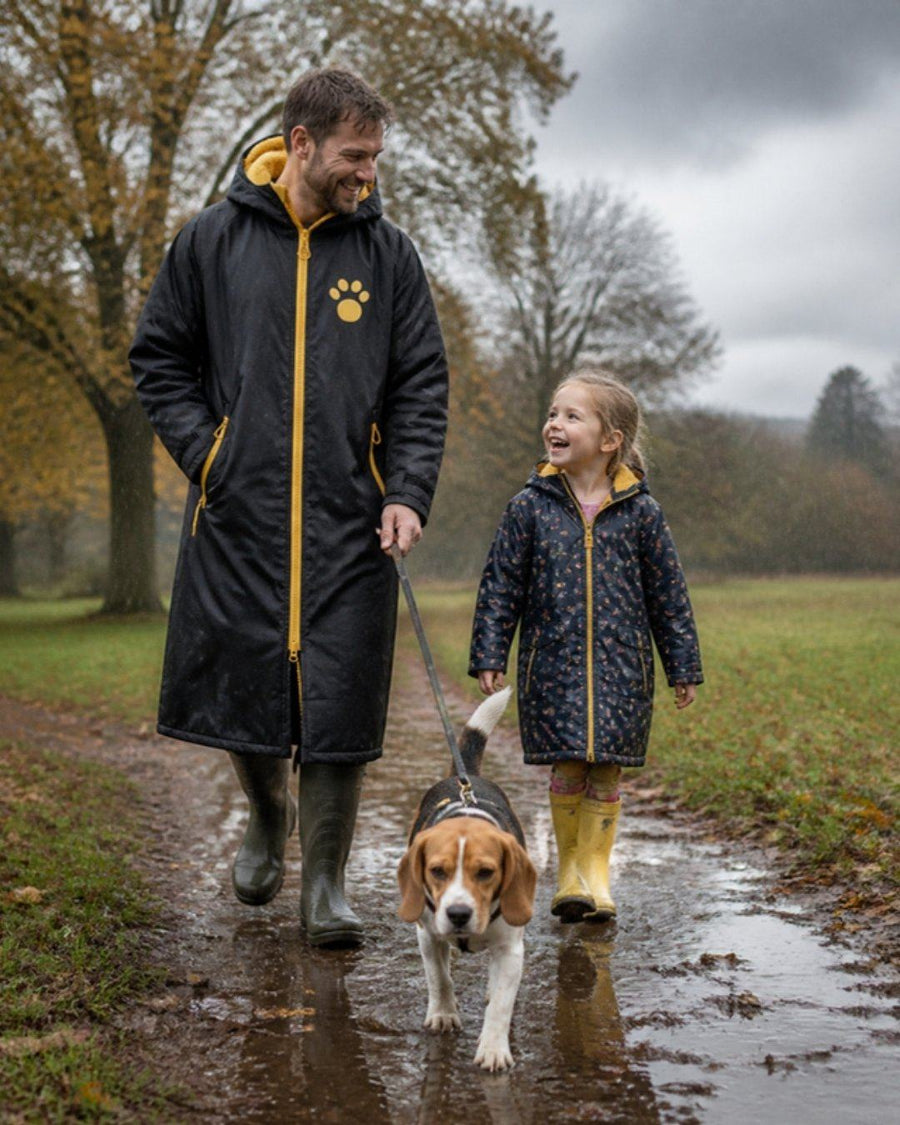 Black and yellow Pooch All Season Robe on a rainy park walk