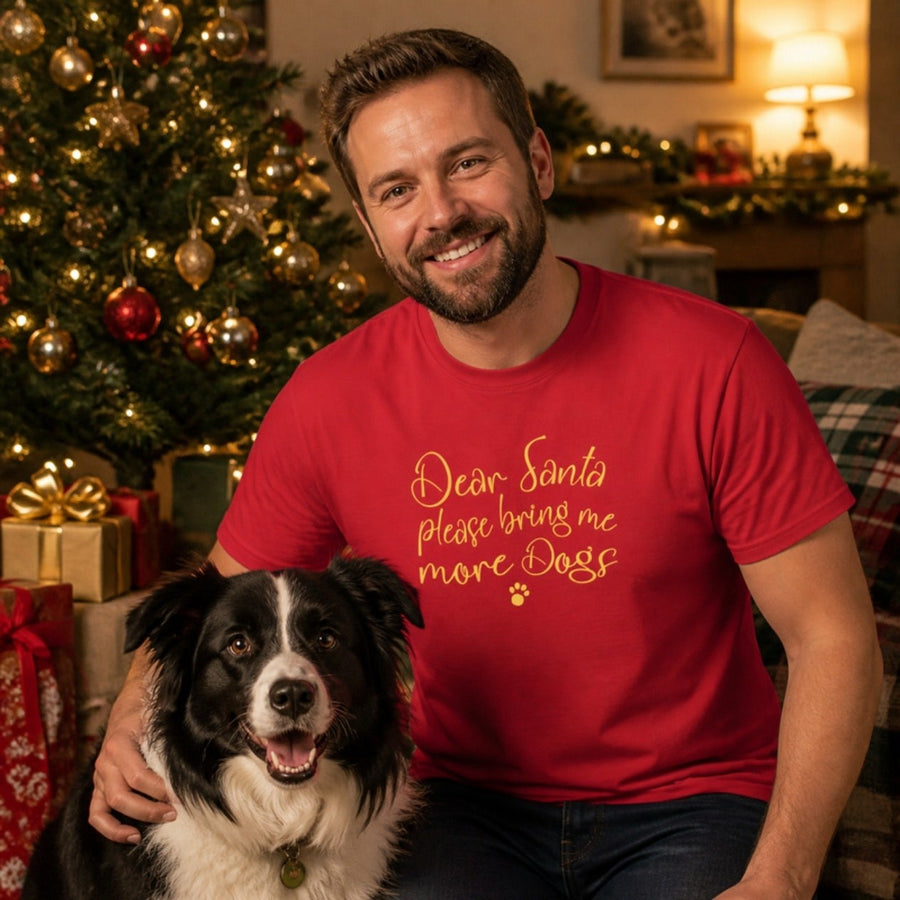 Man wearing the red Bring Me More Dogs Christmas T-shirt with his Border Collie by the Christmas tree