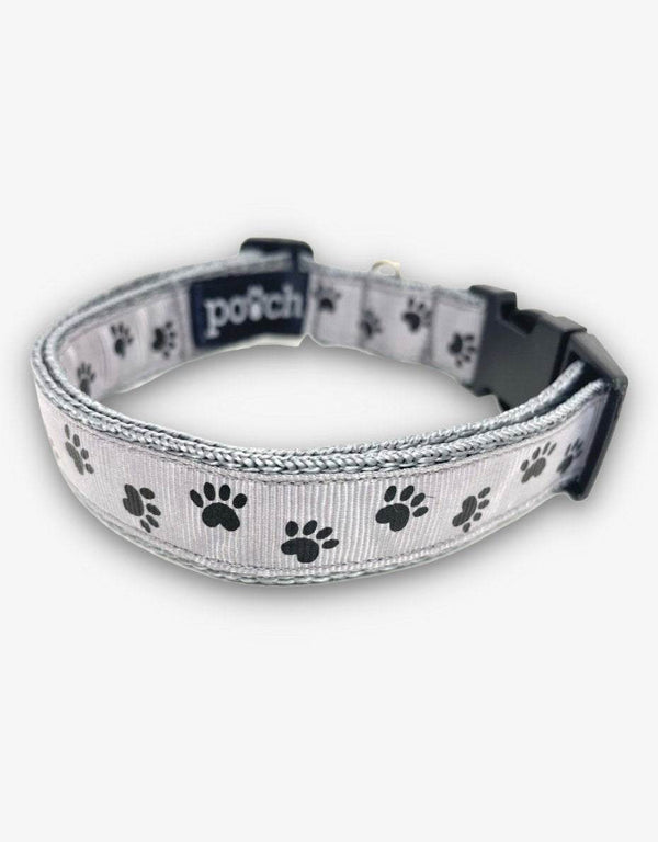 Grey paw print dog collar with adjustable high-quality webbing and durable clip.