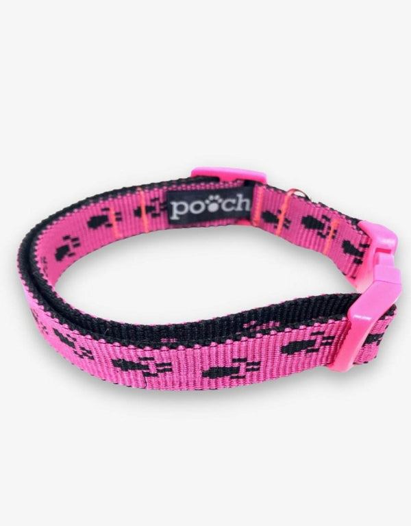 Adjustable pink paw print dog collar with durable clip and stainless steel D-rings.