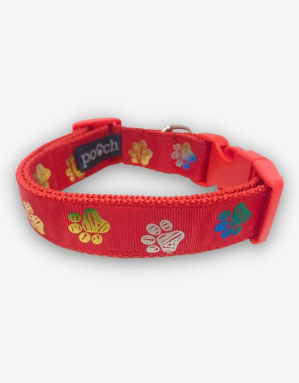 Red paw print dog collar with colorful paw designs and sturdy clasp.