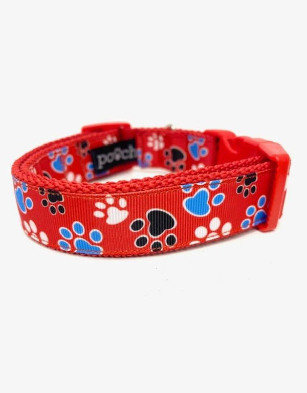 Adjustable red paw print dog collar with durable clip and stainless steel D-rings.
